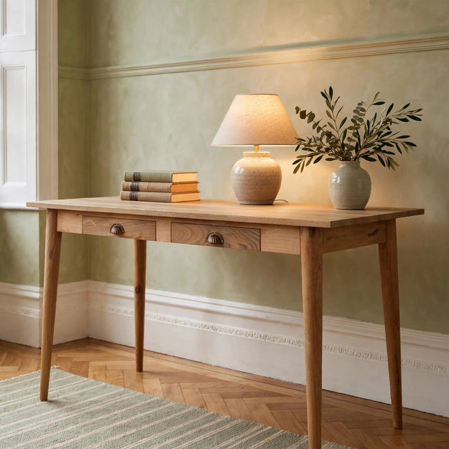 Light solid mango wood Nordic writing desk with two drawers, shown in a room setting