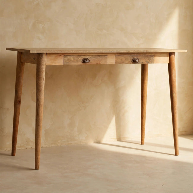 Nordic writing desk with a natural oak-like finish and four slim legs, styled in a study