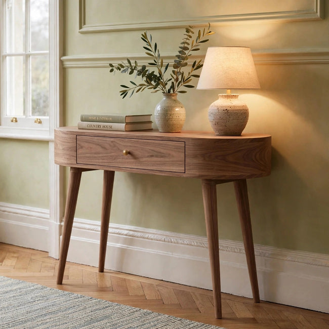 Albion light walnut console table in a room setting, showing its rounded edges and Nordic style legs