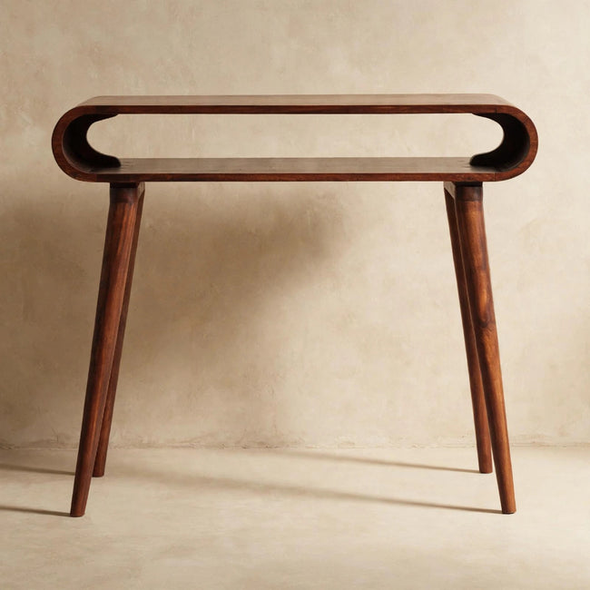 Chestnut finish mango wood console table with open Nordic-style legs in a room