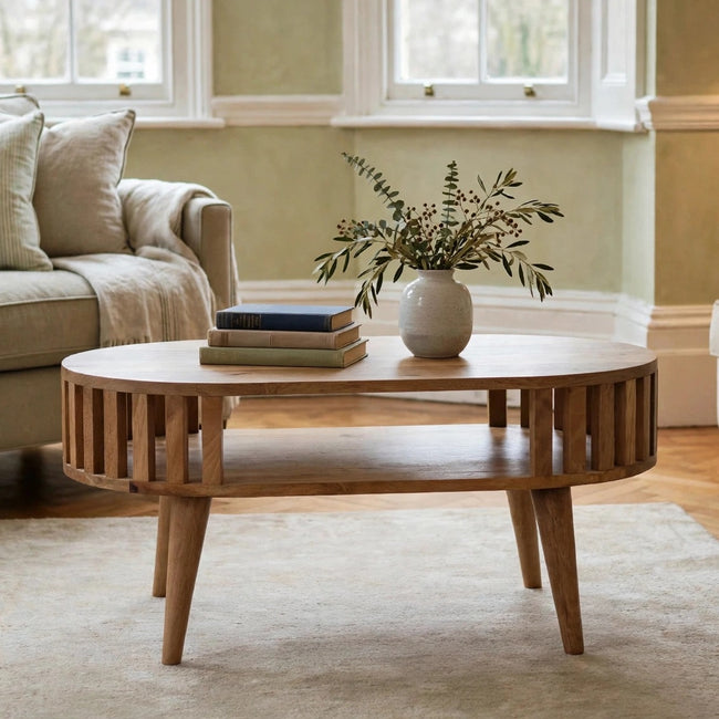 Ariella solid mango wood coffee table with an oak-ish finish in a styled living room