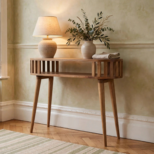 Ariella solid mango wood console table with an oak-style finish in a room setting
