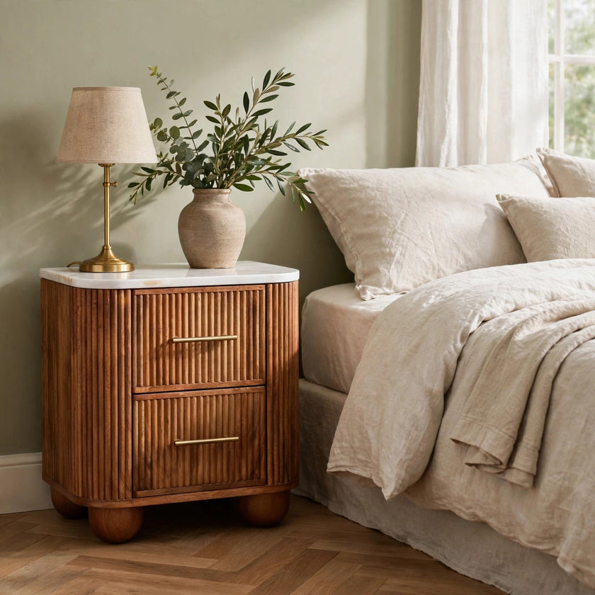 Aurora marble bedside table with golden teak finish styled in a bedroom