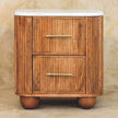 Aurora marble top bedside table standing next to a bed