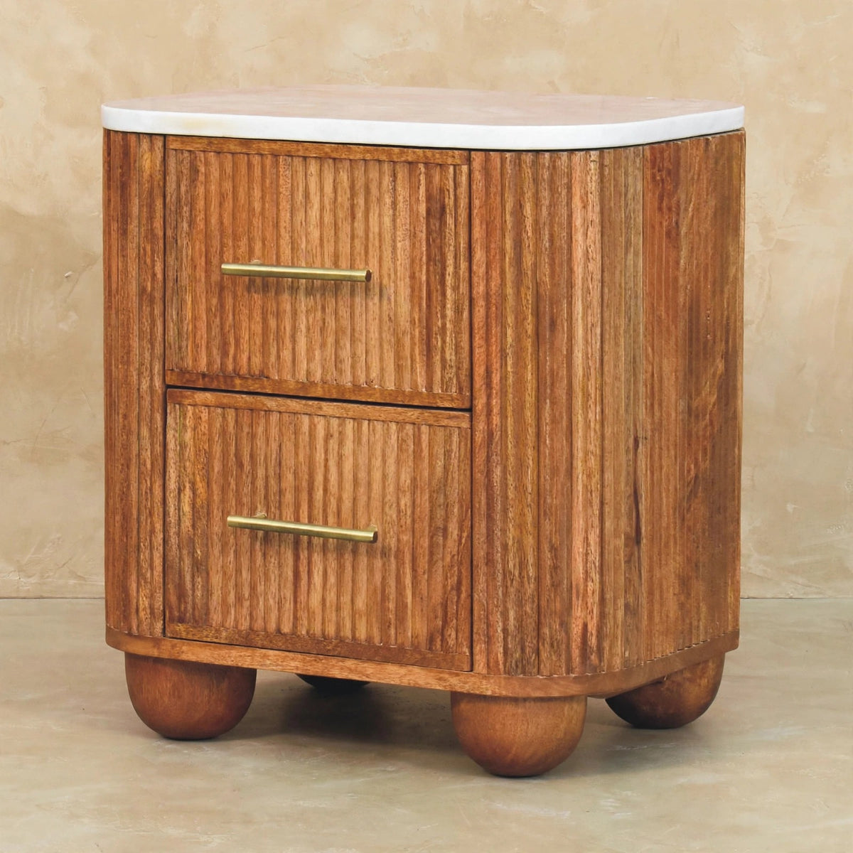 Close view of the marble top and fluted drawers of the Aurora bedside table
