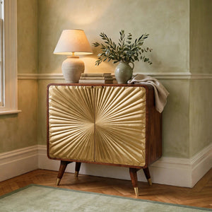 Avora brass embossed 2 door chestnut cabinet styled in a living room