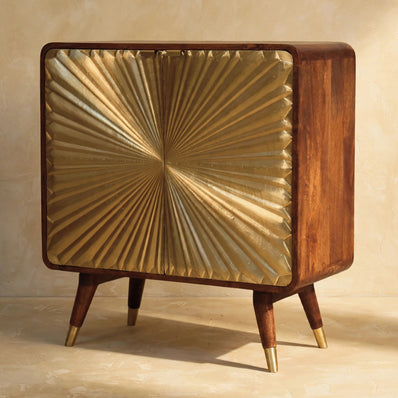 Front view of the Avora mango wood cabinet with brass embossed sunburst doors