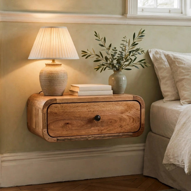 Avora Mini wall-mounted nightstand in solid mango wood with an oak-ish finish, shown in a bedroom