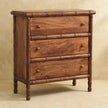 Three-drawer chest with bamboo-style carved framing and a roasted almond finish