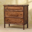 Carved mango wood chest with antique brass knobs shown in a room
