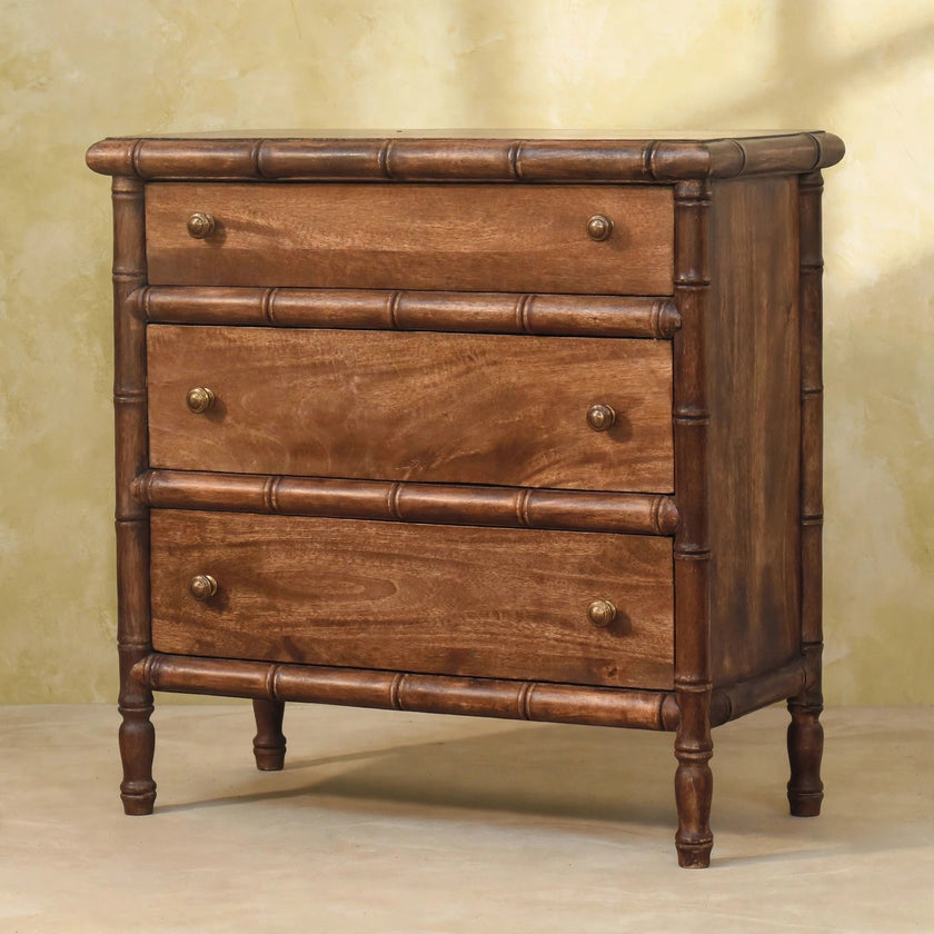 Carved mango wood chest with antique brass knobs shown in a room