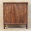 Close view of the wood grain and bamboo carving on the three-drawer chest