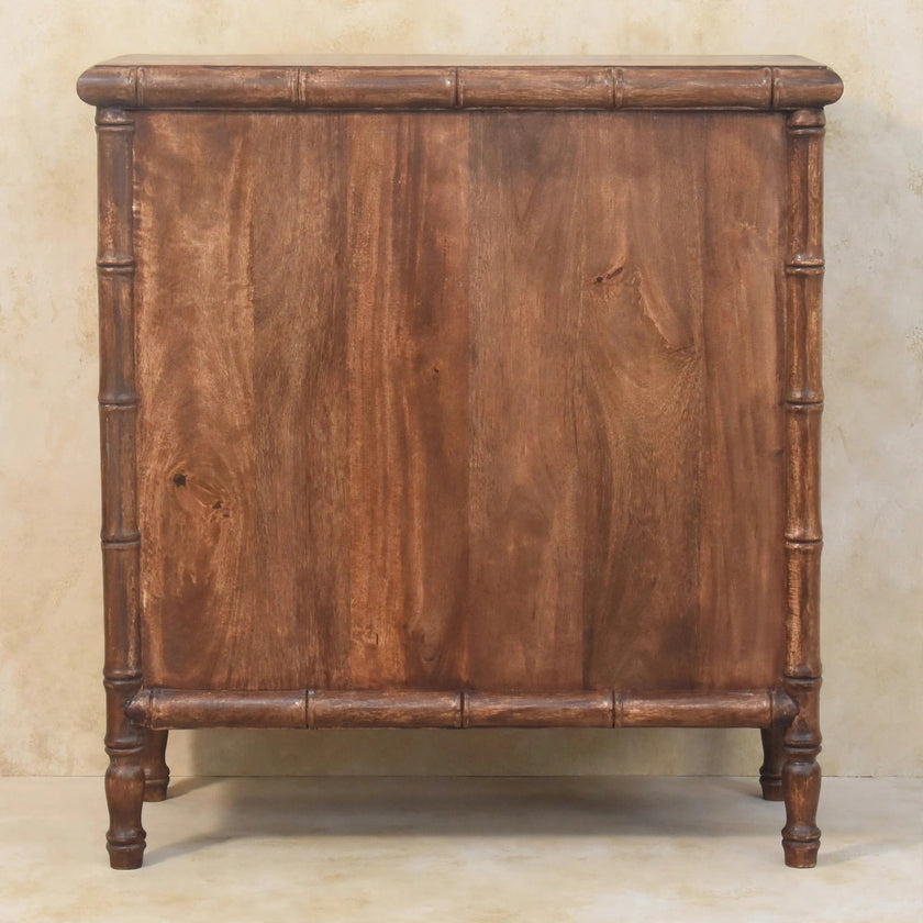 Close view of the wood grain and bamboo carving on the three-drawer chest