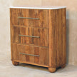 Front view of the chest with fluted drawer fronts and brass handles