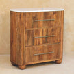 Chest of drawers with four drawers and rounded ball feet in a styled room