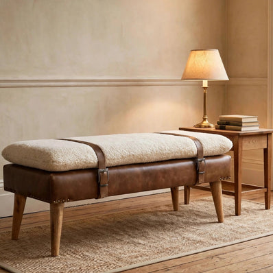 Bouclé bench with buffalo hide leather straps and wooden legs styled in a living space