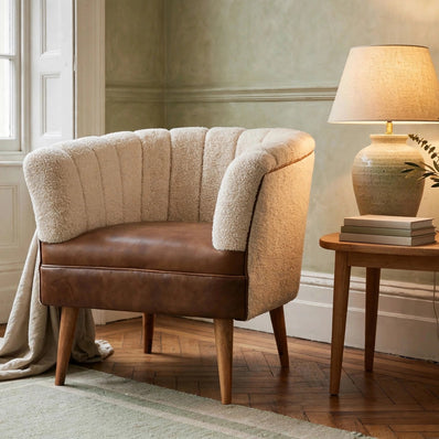 Cream boucle armchair with mango wood legs in a styled living room