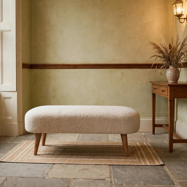 Boucle hallway bench with a cushioned cotton bouclé seat and solid mango wood legs in a hallway