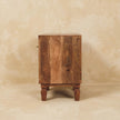 Carved mango wood shoe cabinet placed against a hallway wall