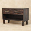 Close view of the carved mango wood drawer fronts on the shoe storage bench