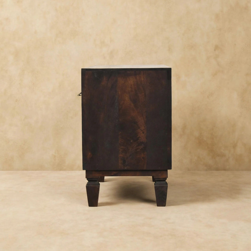 Carved shoe storage bench in a bedroom or dressing space setting