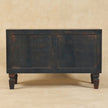 Side view of the Velvet Mocha mango wood shoe storage bench in a room