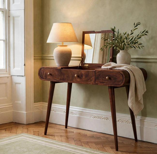 Walnut-finish dressing table with foldable mirror set up in a bedroom