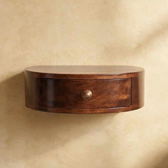 California walnut wall mounted bedside table fixed to the wall beside a bed in a styled room