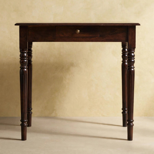 Front view of the walnut writing desk showing the drawer and shell handles