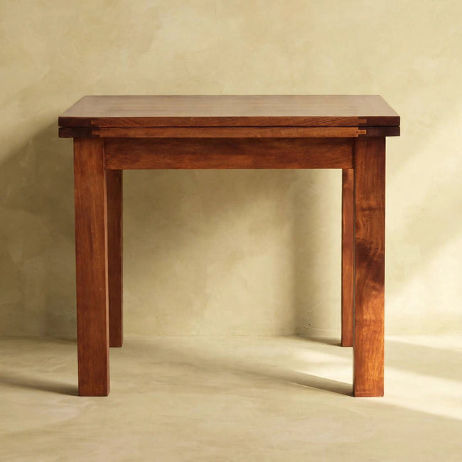 Square mango wood butterfly dining table with an oak-ish finish, seen from another angle
