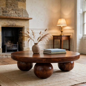 Chestnut solid mango wood coffee table with ball feet in a living room
