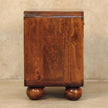 Woven bedside table in a styled bedroom corner