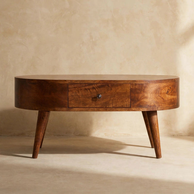 Close view of the chestnut coffee table's curved edges and Nordic-style legs