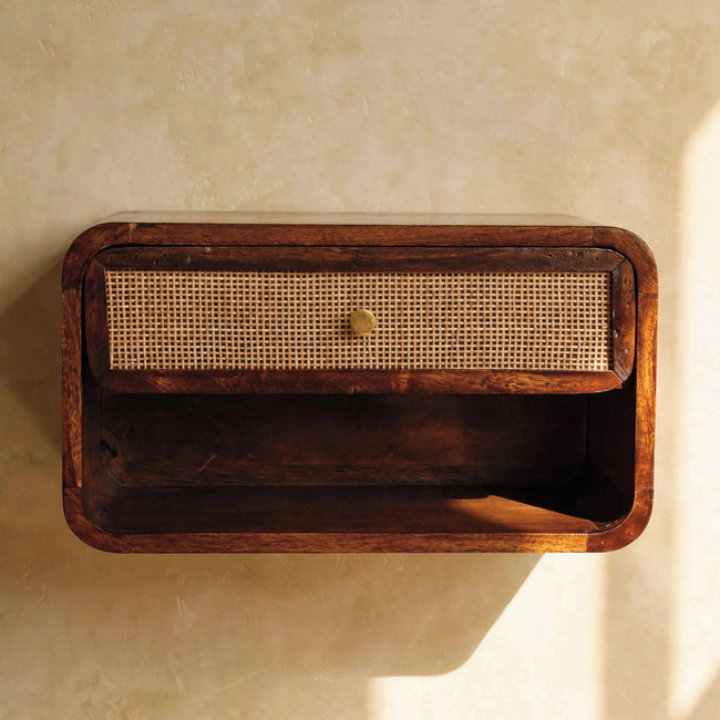 Wall mounted open woven bedside table in a chestnut finish next to a bed