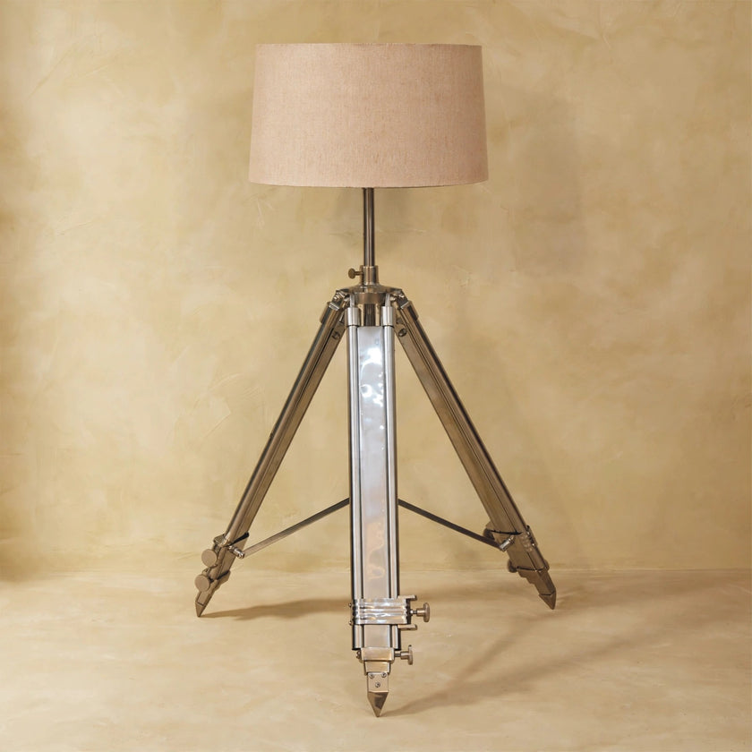 Chrome tripod base and neutral lampshade in a home interior