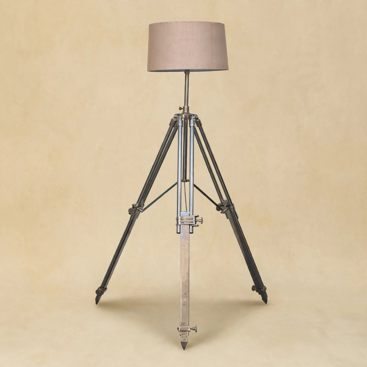 Chrome tripod lamp used as a modern accent light in a room