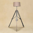 Chrome tripod lamp used as a modern accent light in a room