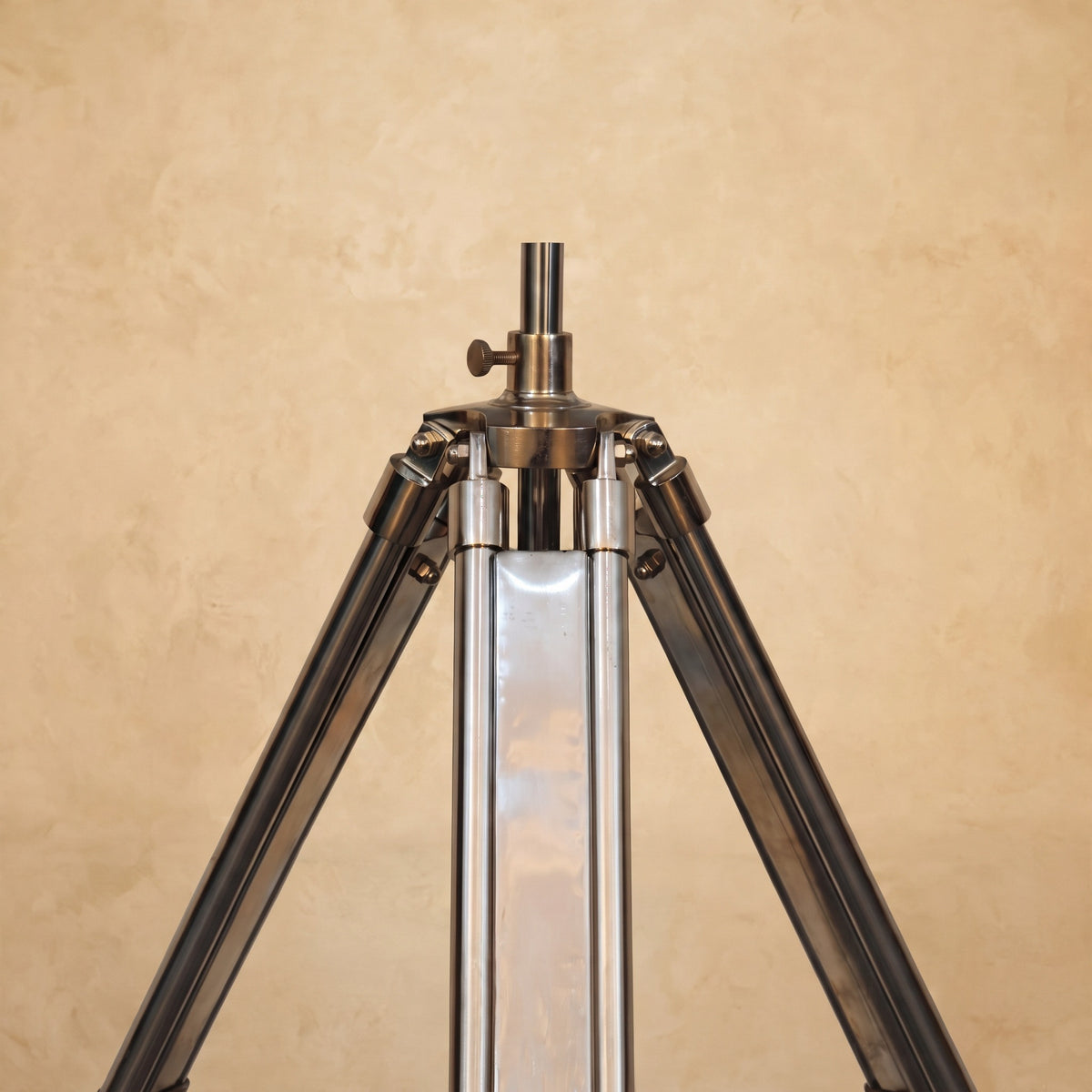 Chrome tripod lamp adding a modern and rustic touch to a room