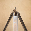 Chrome tripod lamp adding a modern and rustic touch to a room