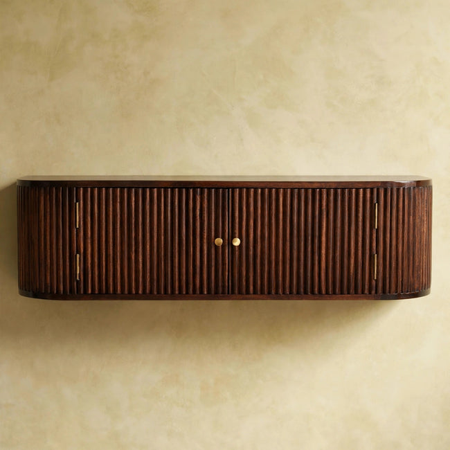 Chestnut wall mounted console table with slatted front and brass-toned knobs in a room setting
