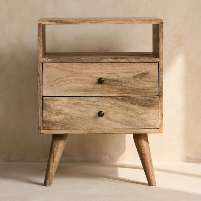 Mango wood bedside table with Nordic-style legs next to a bed
