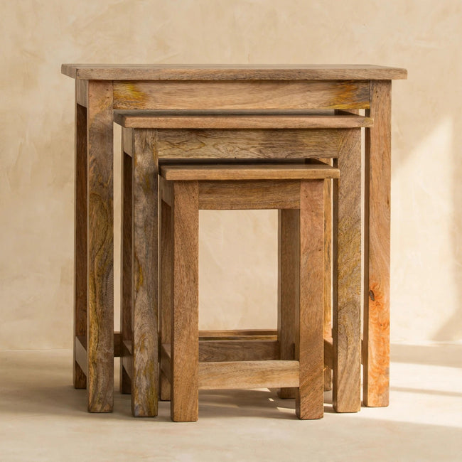 Three hand-distressed mango wood stools arranged together in a styled room