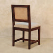 Close-up of the chestnut finish mango wood leg and frame on the cream boucle chair