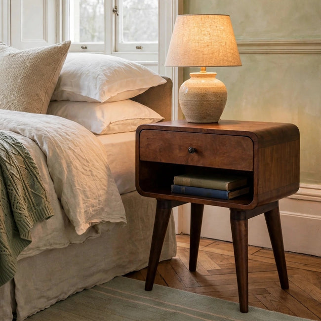 Curve Open Slot chestnut bedside table in solid mango wood, shown in a bedroom setting