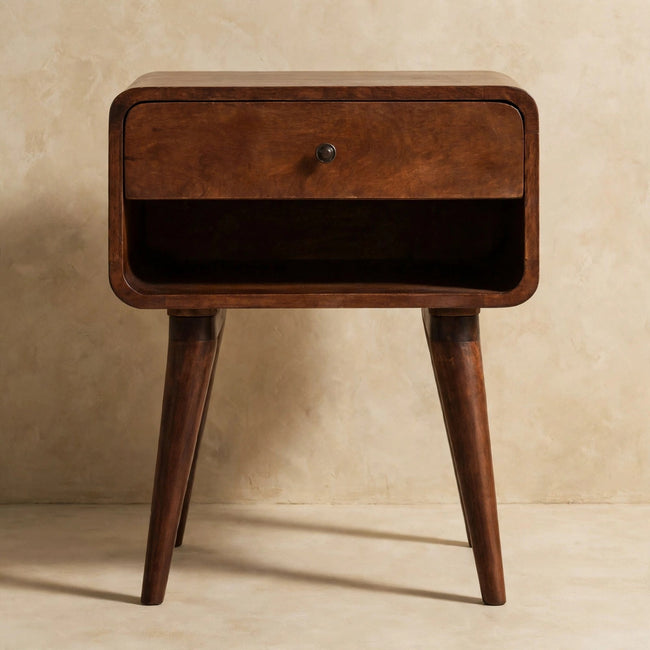 Chestnut mango wood bedside table with curved edges and a drawer with a metal knob