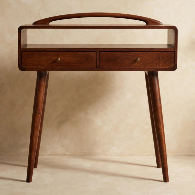 Chestnut console table with curved edges and shiny drawer knobs styled in a room