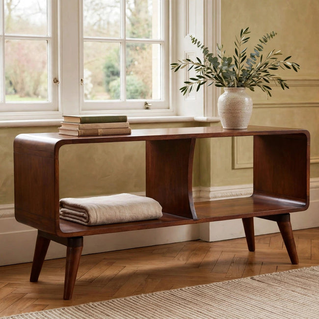 Curved chestnut mango wood media unit with two open slots and Nordic-style legs in a living room