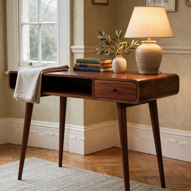 Curved chestnut mango wood writing desk set up in a study