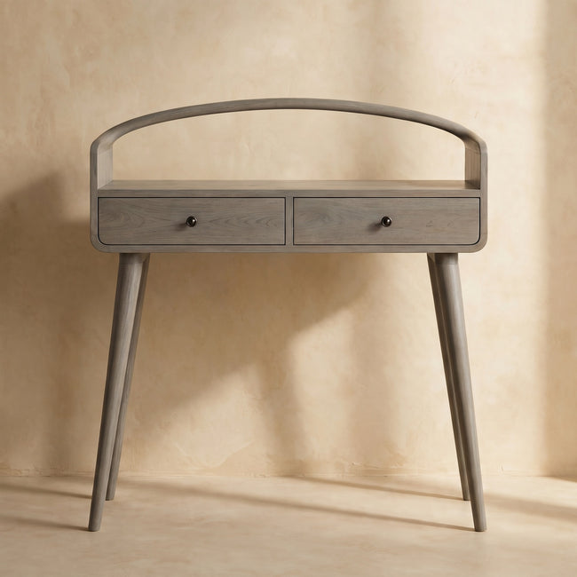 Grey-wash console table with curved edges and brass drawer knobs styled in a hallway