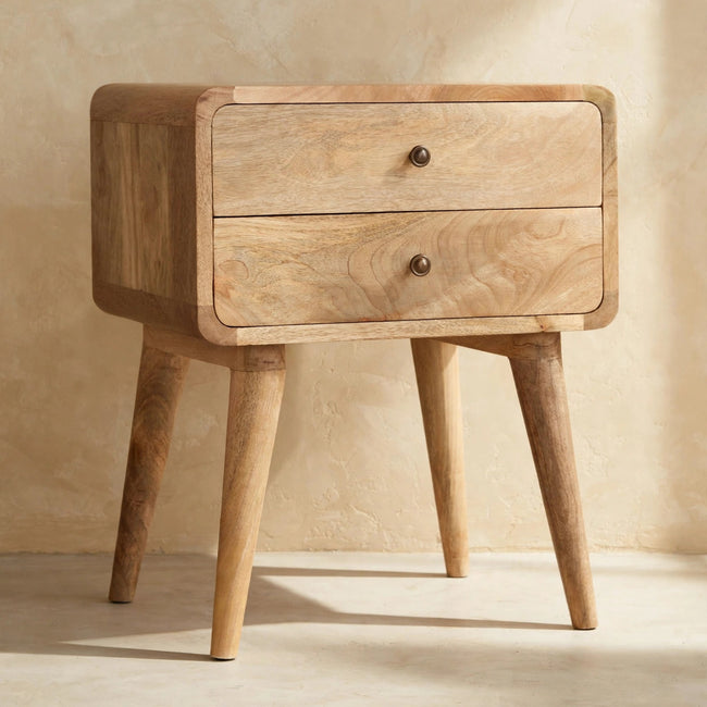 Solid mango wood bedside table with shiny drawer knobs and Nordic-style legs in a room